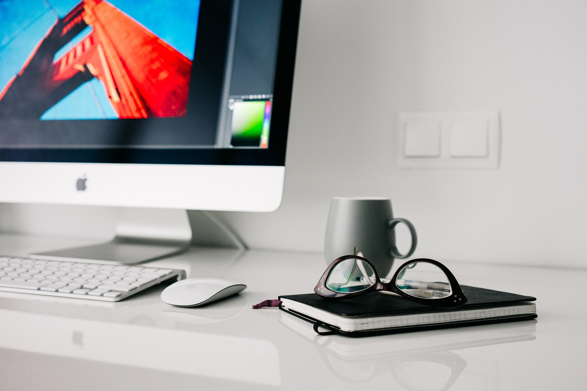 glasses and book near computer